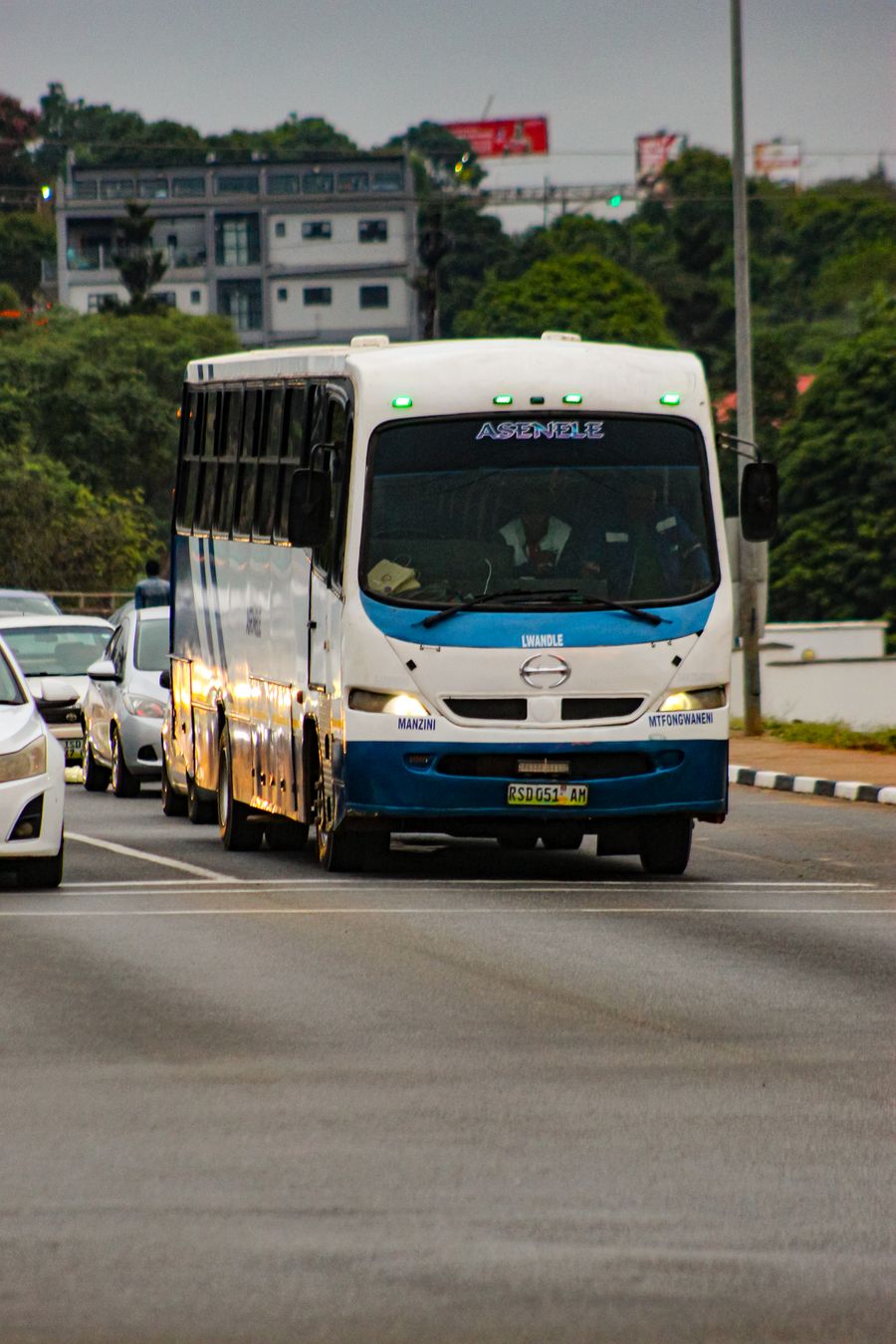 White minibus in city traffic