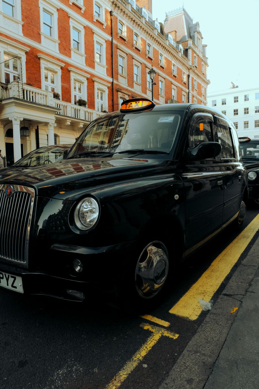 Black London taxi on a city street